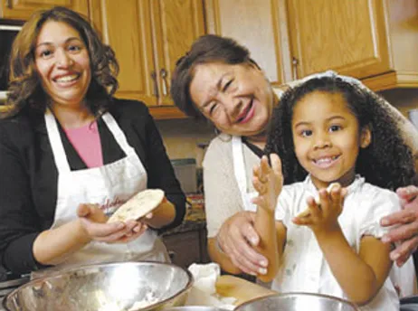 Susy, Carmen and Karina make pupusas in their family kitchen